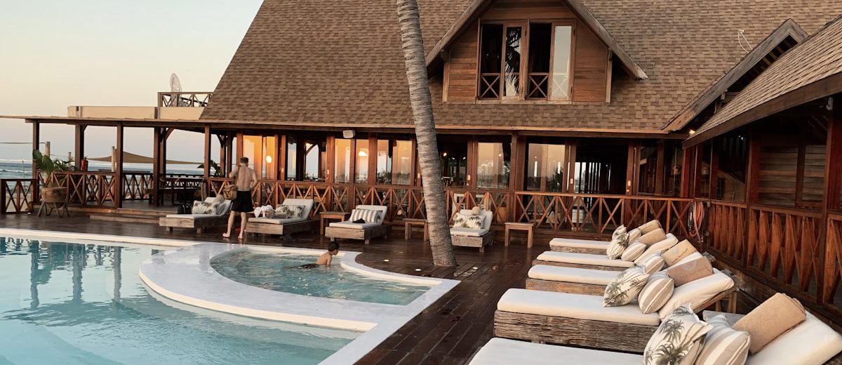 Beautiful resort hotel pool with palm trees and blue sky
