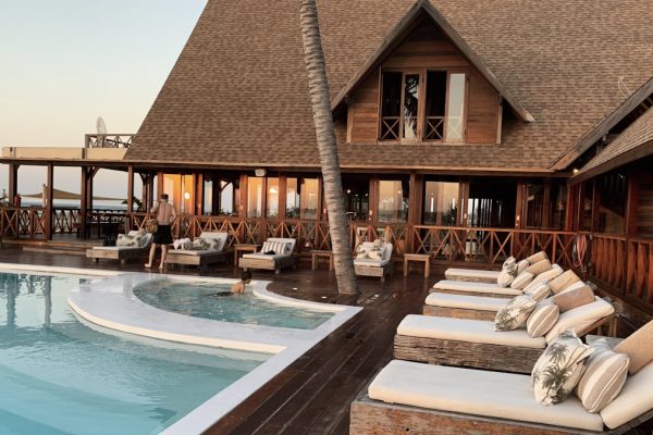 Beautiful resort hotel pool with palm trees and blue sky